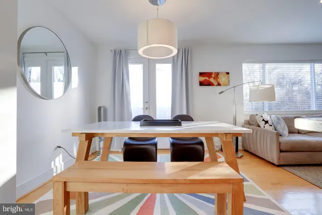 a living room with furniture a table and potted plants