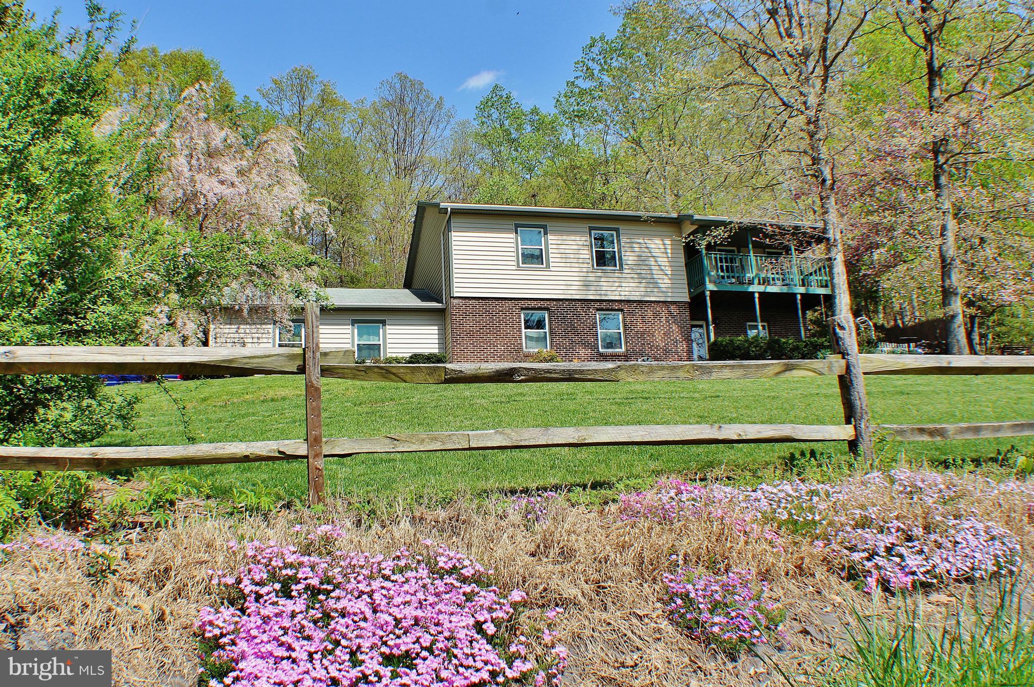 18049 Possum Point Road Dumfries, VA 22026 - Photo 1 of 30 a front view of a house with garden