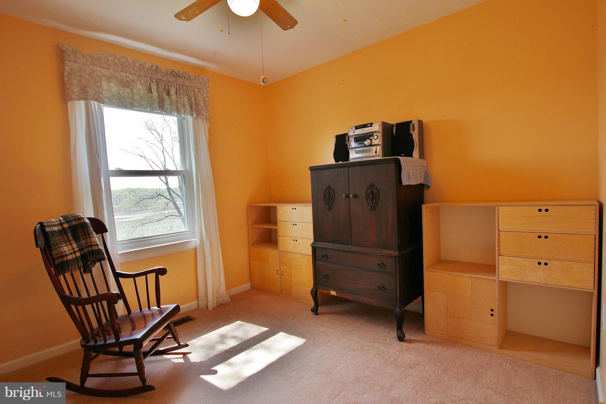 18049 Possum Point Road Dumfries, VA 22026 - Photo 14 of 30 a view of a workspace with furniture and a window