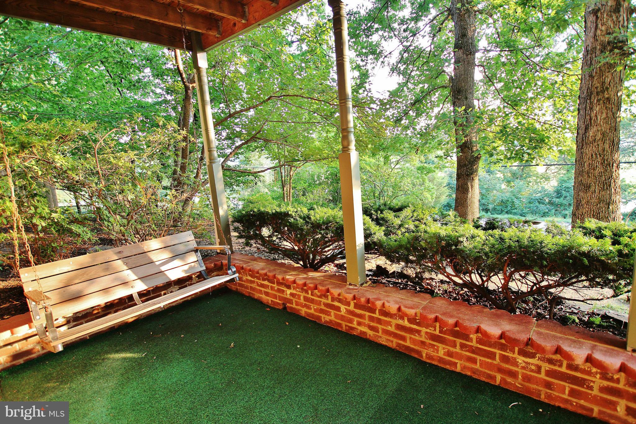 18049 Possum Point Road Dumfries, VA 22026 - Photo 24 of 30 a backyard of a house with a garden and outdoor seating