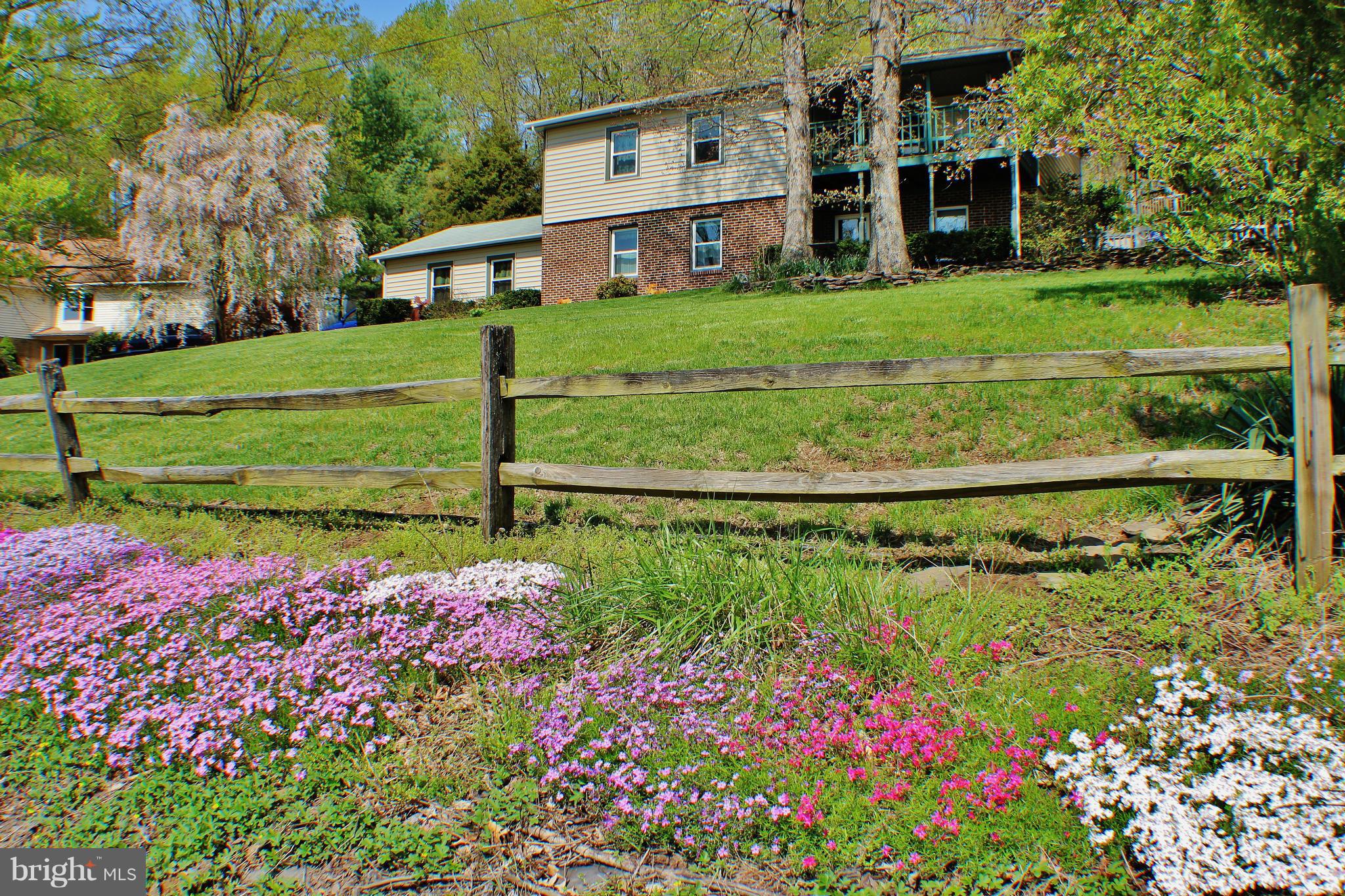 18049 Possum Point Road Dumfries, VA 22026 - Photo 28 of 30 a view of a house with a big yard and potted plants