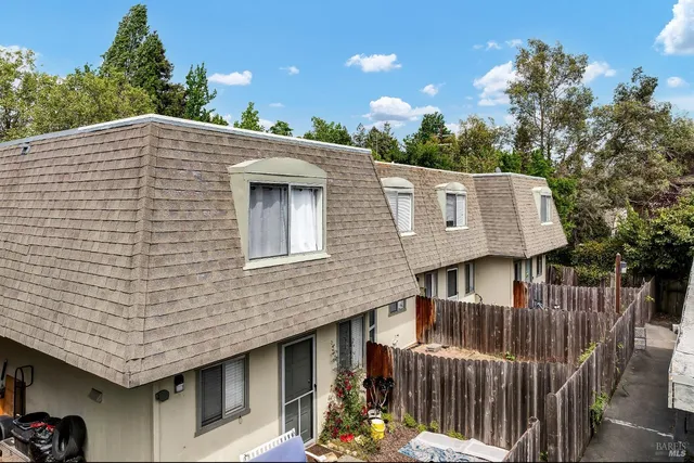 a pathway of a house with wooden fence