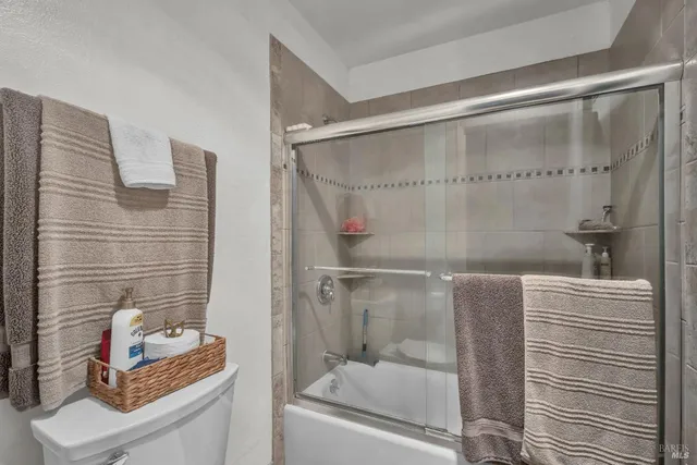 a view of a chair and tables in the back yard