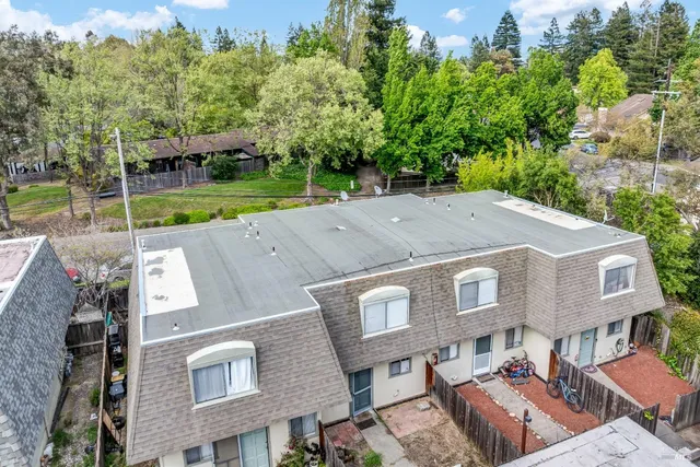 an aerial view of a house with swimming pool and garden