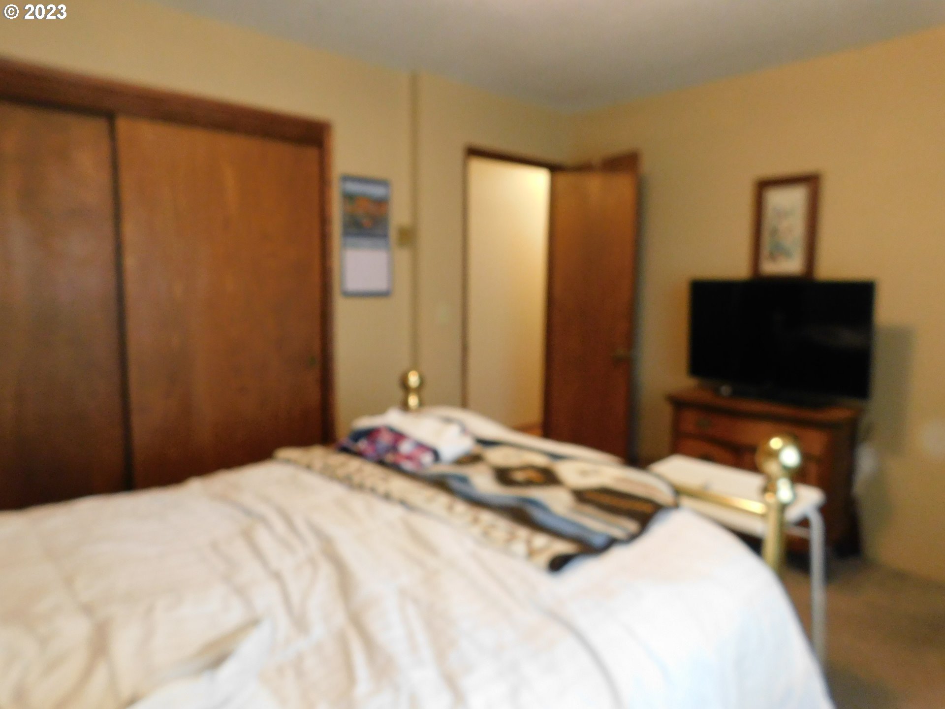 1968 View Street Myrtle Point, OR 97458 - Photo 18 of 27 a bedroom with a bed and a flat screen tv