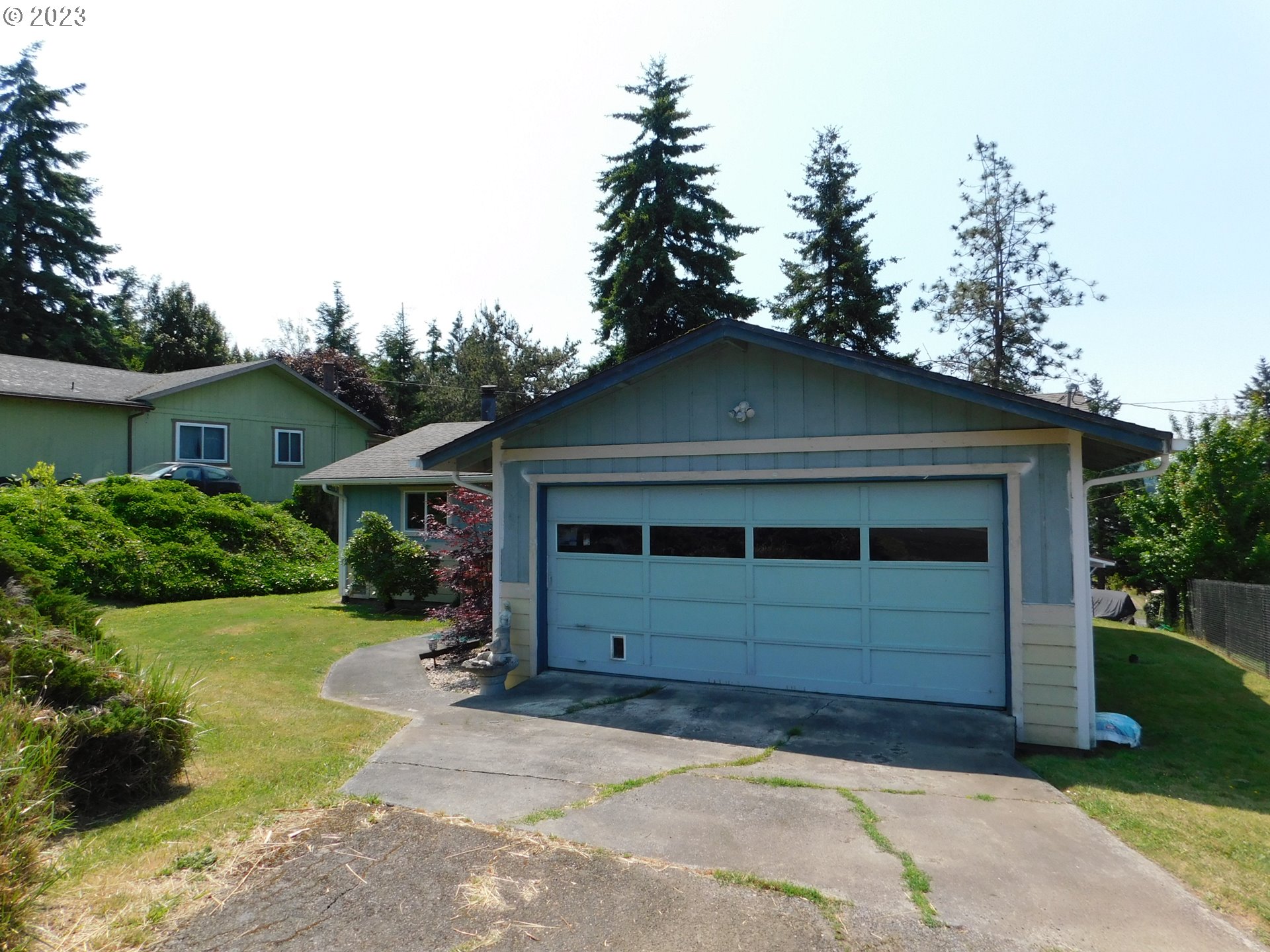 1968 View Street Myrtle Point, OR 97458 - Photo 4 of 27 a front view of a house with a yard and garage