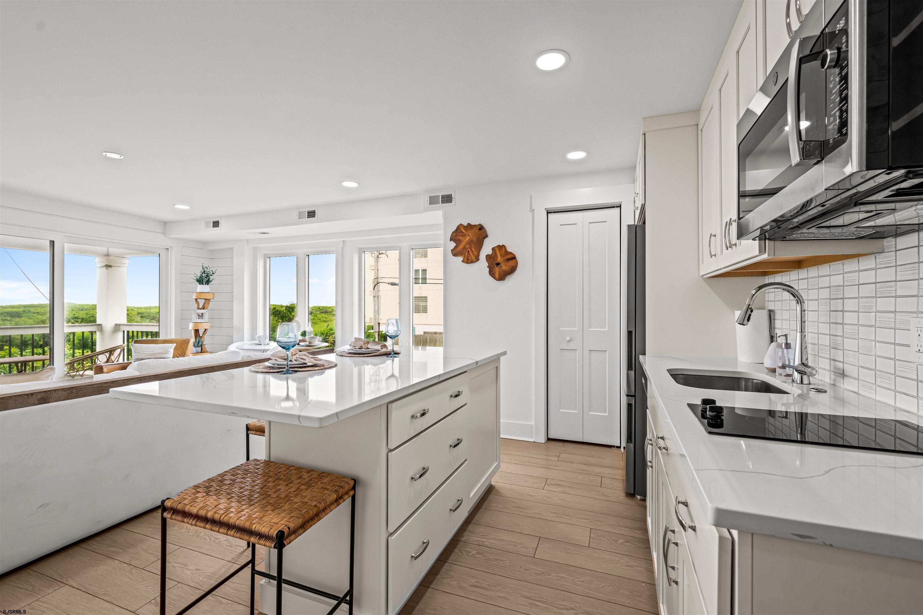 321 South 6th Street, Unit 4 Brigantine, NJ 08203 - Photo 15 of 26 a kitchen with stainless steel appliances granite countertop a sink and a stove