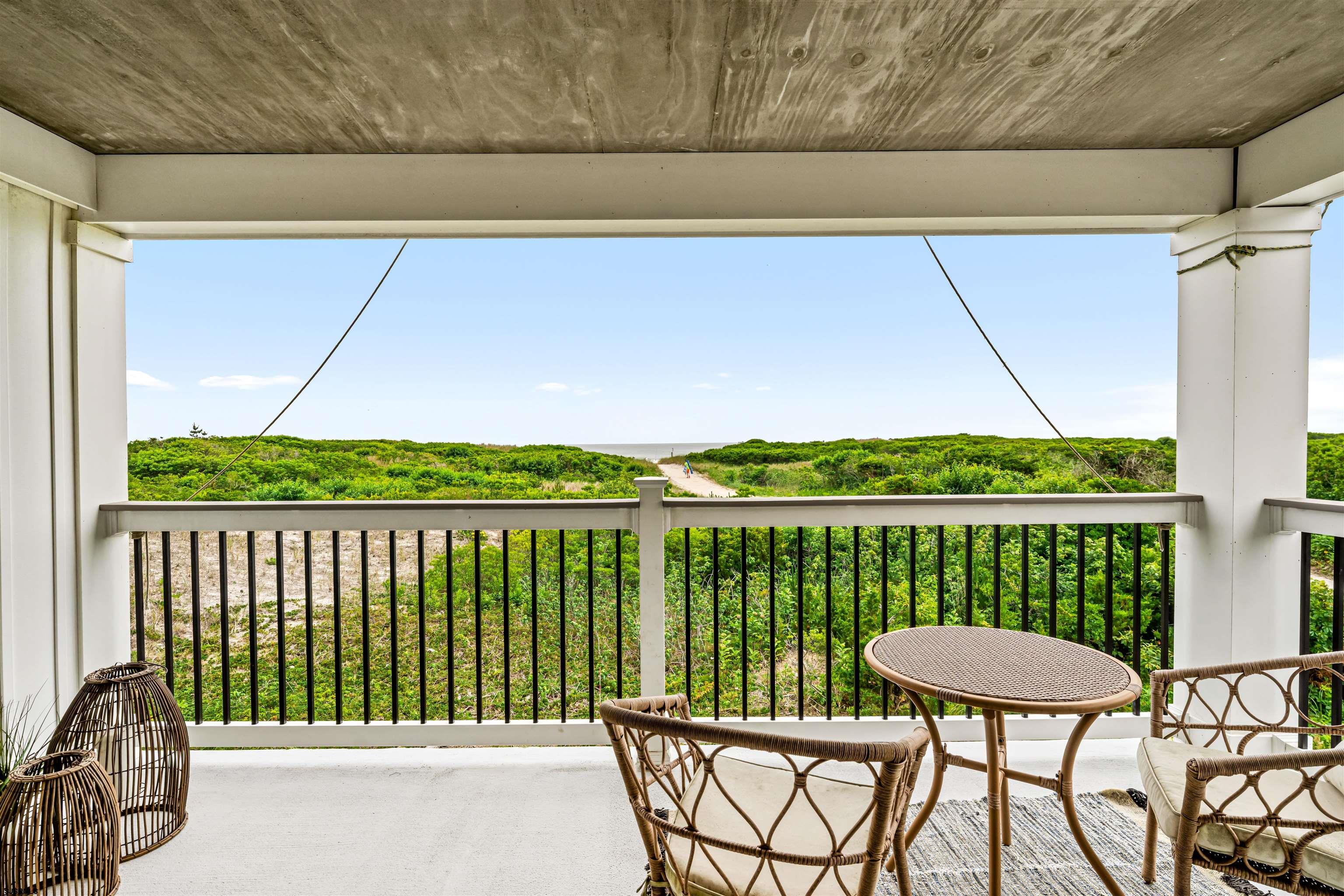 321 South 6th Street, Unit 4 Brigantine, NJ 08203 - Photo 20 of 26 a balcony with a table and chairs