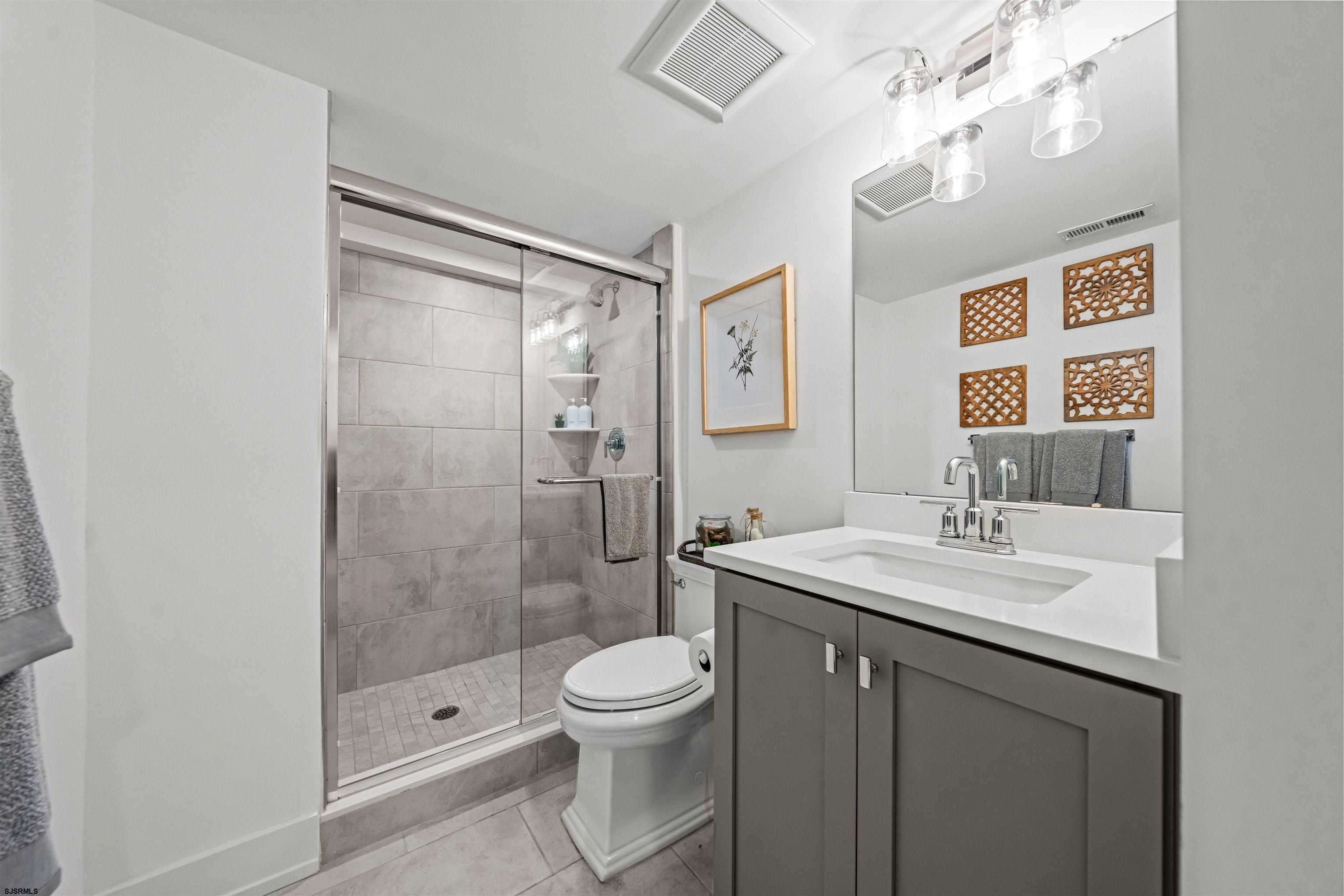 321 South 6th Street, Unit 4 Brigantine, NJ 08203 - Photo 8 of 26 a bathroom with a sink a toilet and shower