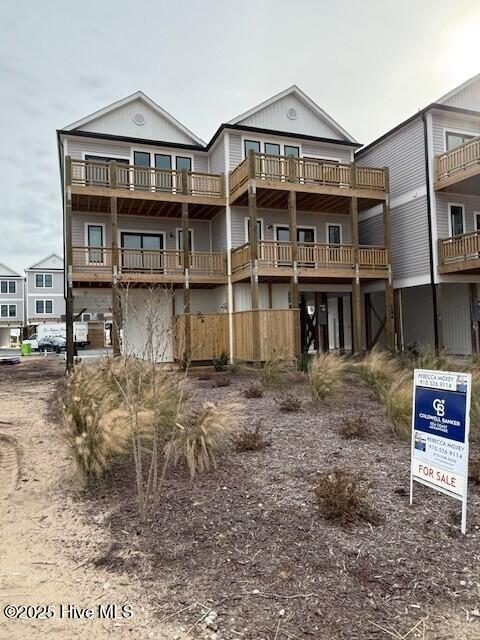 126 Shell Road Surf City, NC 28445 - Photo 2 of 40 126 Shell Front with my sign