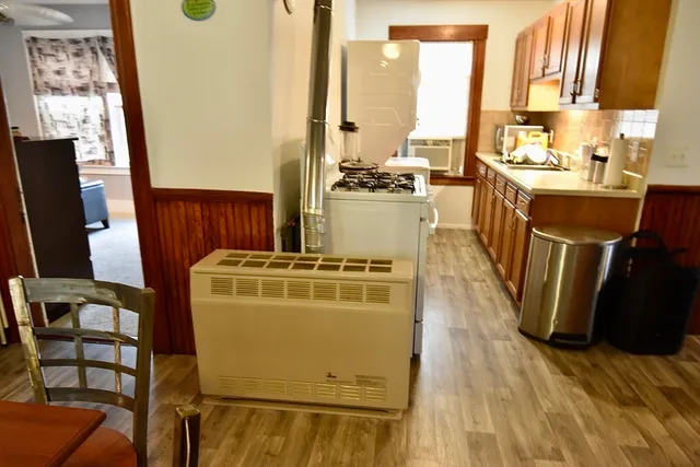 a view of a kitchen with appliances cabinets and wooden floor