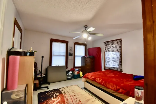 a bedroom with a bed and closet with mirror