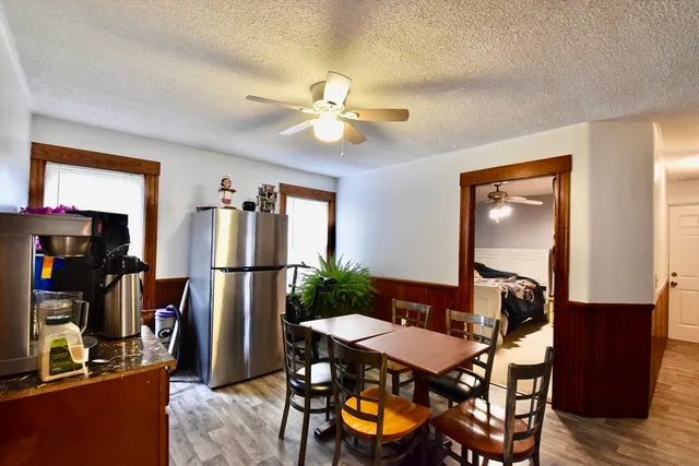 a view of a dining room with furniture and a chandelier