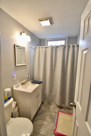a bathroom with a sink mirror vanity and toilet