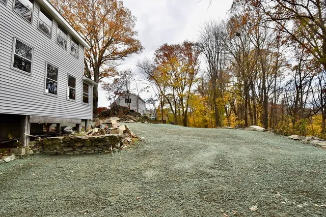 a backyard of a house with table and chairs