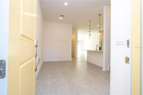a large white kitchen with a refrigerator a sink and a stove