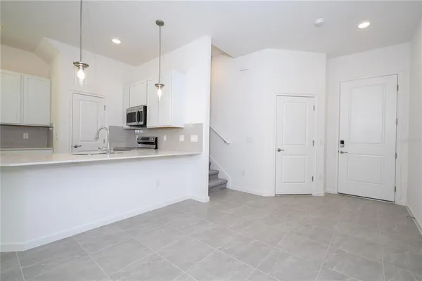 a kitchen with kitchen island a sink stainless steel appliances and cabinets