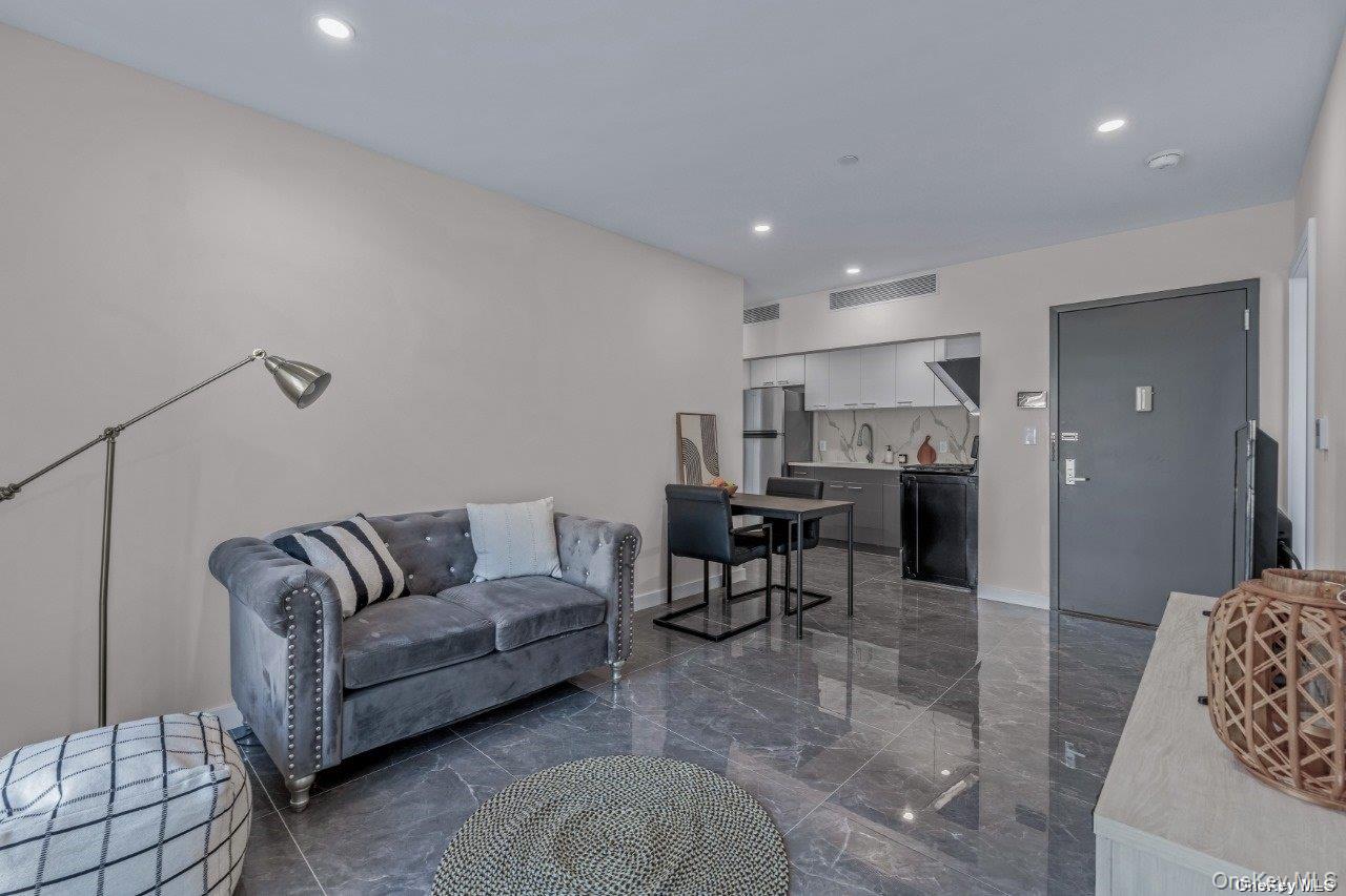 43-30 52nd Street, Unit 3B Queens, NY 11377 - Photo 4 of 14 a living room with furniture and view of kitchen