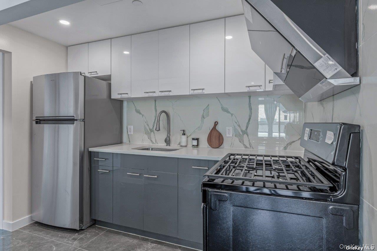 43-30 52nd Street, Unit 3B Queens, NY 11377 - Photo 6 of 14 a kitchen with a stove and a refrigerator