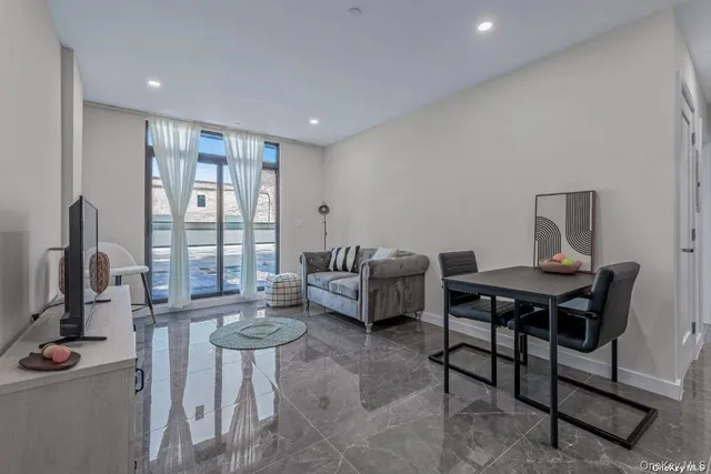 a living room with furniture a window and a table