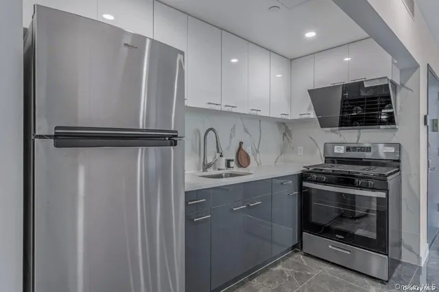 a kitchen with stainless steel appliances a refrigerator sink and microwave