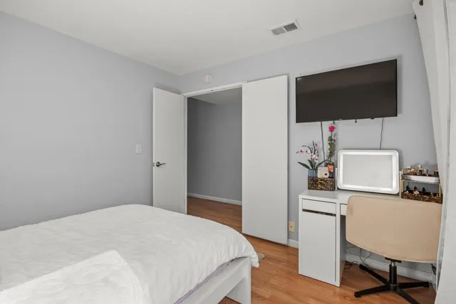 a bedroom with a bed and a flat screen tv