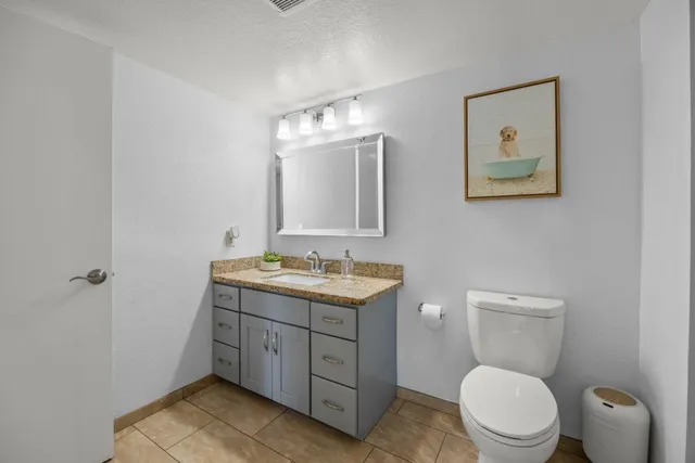 a bathroom with a toilet a sink and mirror