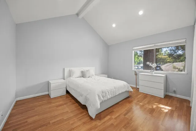 a bedroom with a bed and a large window