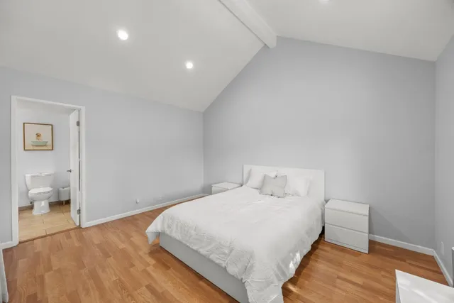 a bedroom with a bed and a lamp