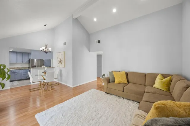 a living room with furniture and a chandelier