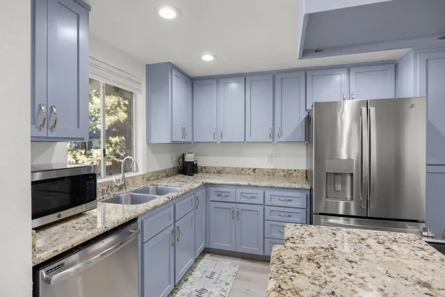 a kitchen with a sink stove and refrigerator