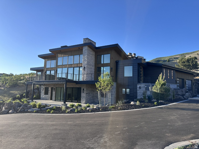1918 Chimney Rock Road Heber City, UT 84032 - Photo 1 of 74 Contemporary architectural design featuring extensive glass, stone veneer, and dark wood-look siding