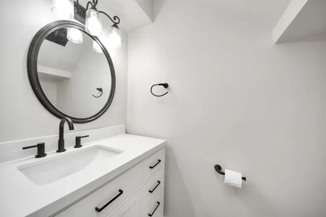 a bathroom with a sink and a mirror