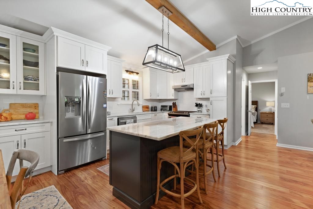 1157 Pine Ridge Road Beech Mountain, NC 28604 - Photo 1 of 41 a kitchen with stainless steel appliances granite countertop a refrigerator a sink dishwasher a stove and a refrigerator with wooden floor