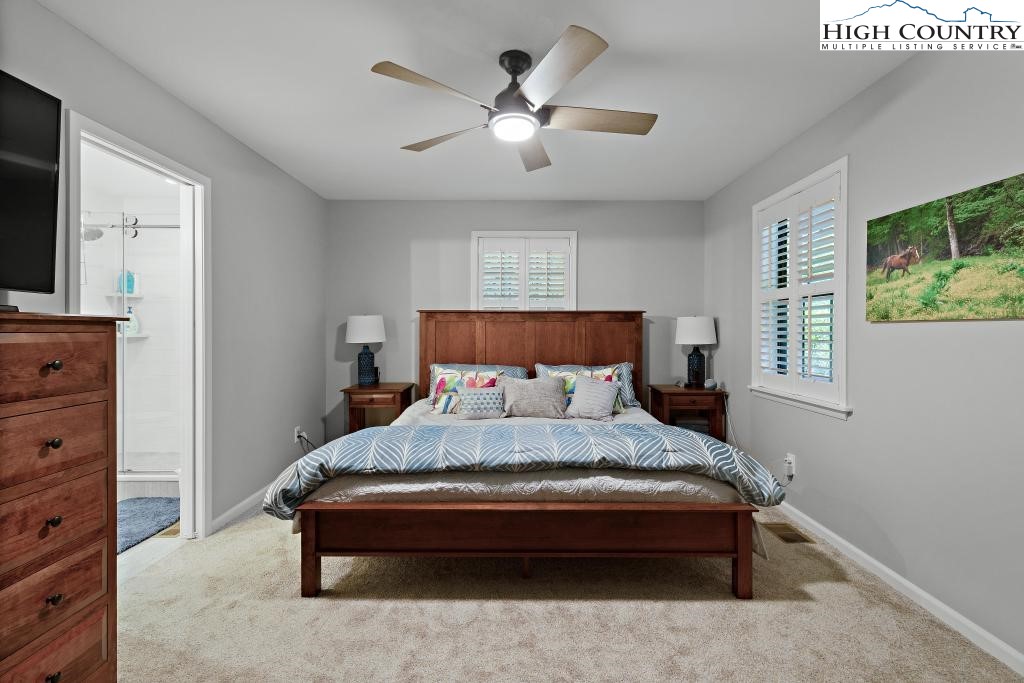 1157 Pine Ridge Road Beech Mountain, NC 28604 - Photo 21 of 41 a bedroom with a bed and a dresser