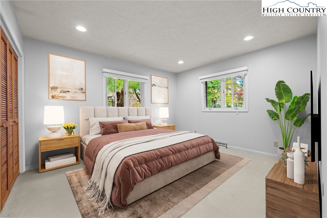 164 Appalachian Drive Boone, NC 28607 - Photo 19 of 43 a bedroom with a bed and a potted plant