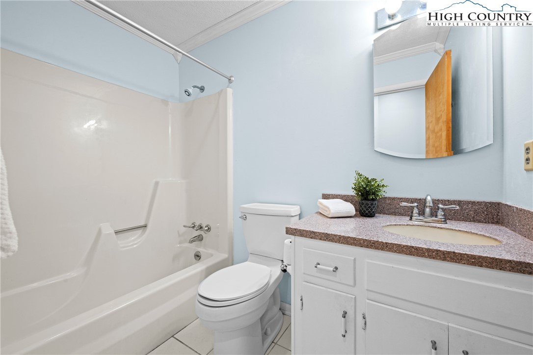 164 Appalachian Drive Boone, NC 28607 - Photo 25 of 43 a bathroom with a granite countertop sink toilet and shower