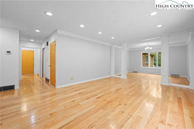 a view of an empty room with wooden floor