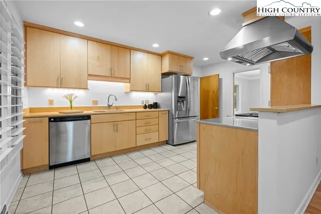 a kitchen with a sink a refrigerator and window