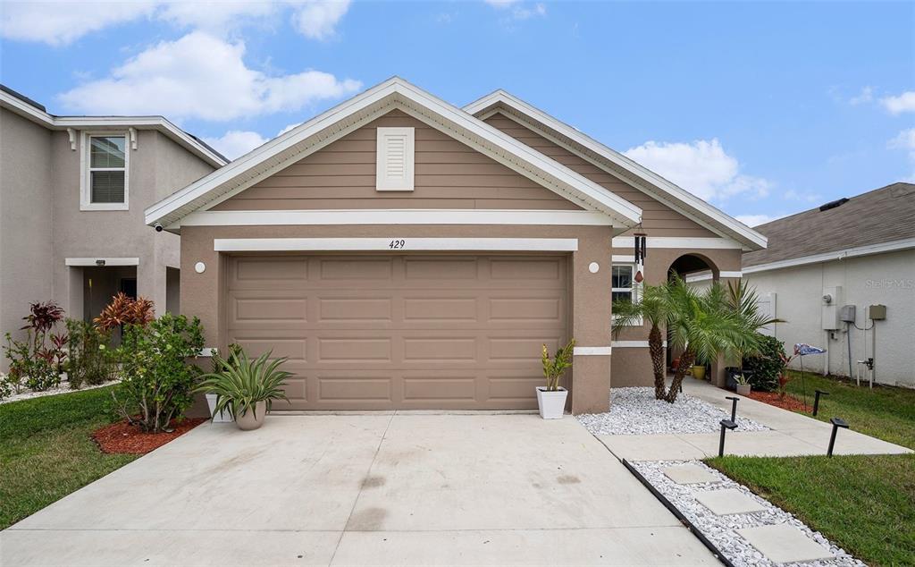 429 Olive Conch Street Ruskin, FL 33570 - Photo 1 of 15 a front view of a house with a yard