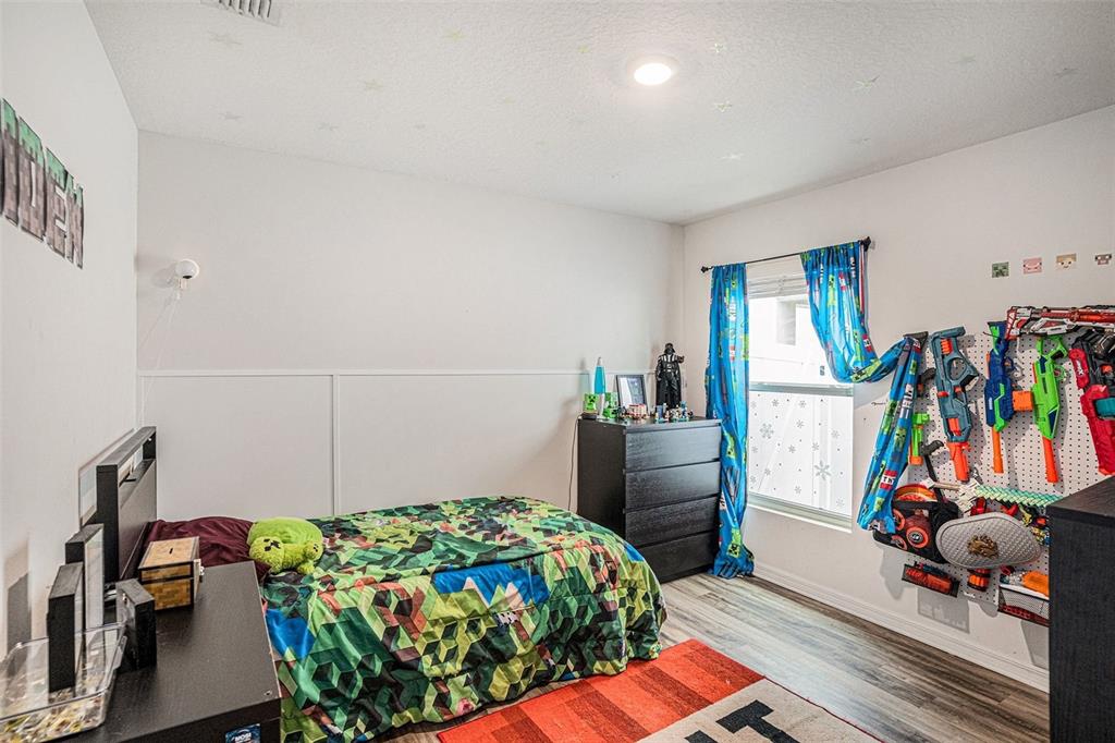 429 Olive Conch Street Ruskin, FL 33570 - Photo 4 of 15 a bedroom with bed and a window