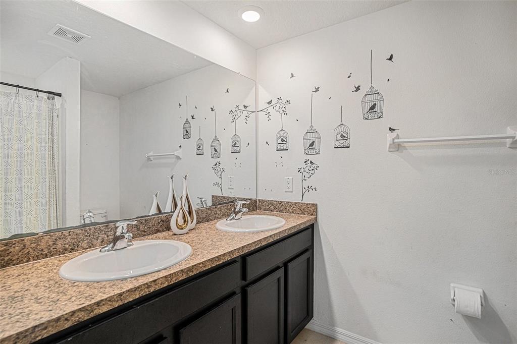 429 Olive Conch Street Ruskin, FL 33570 - Photo 8 of 15 a bathroom with a granite countertop sink and a mirror