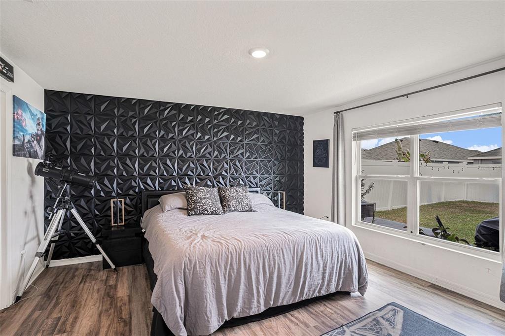 429 Olive Conch Street Ruskin, FL 33570 - Photo 10 of 15 a bedroom with a bed and a large window with balcony view
