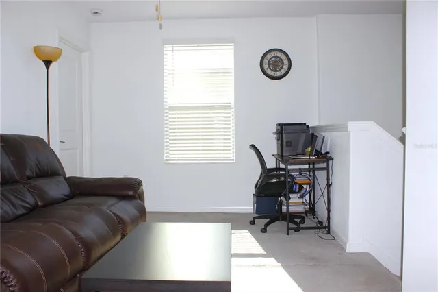 a living room with furniture and a rug