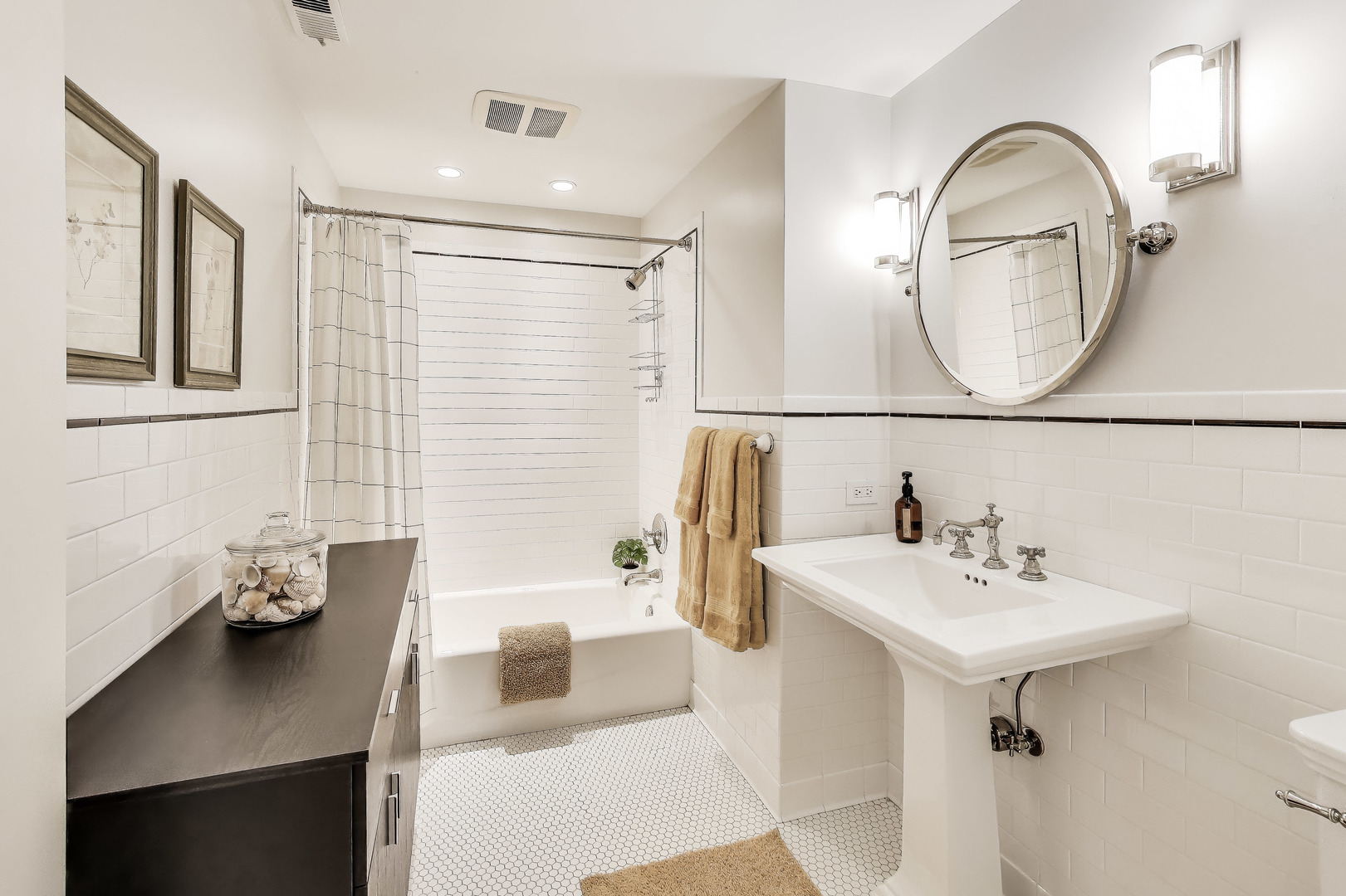 628 West Grace Street, Unit 2W Chicago, IL 60613 - Photo 28 of 32 a bathroom with a sink a mirror and a shower