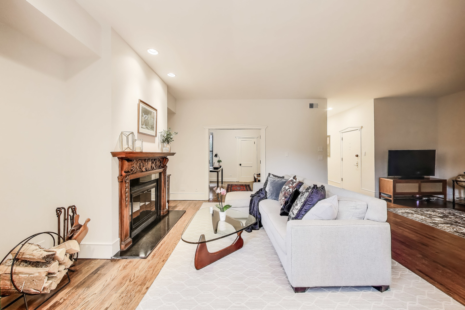 628 West Grace Street, Unit 2W Chicago, IL 60613 - Photo 8 of 32 a living room with furniture a fireplace and a flat screen tv