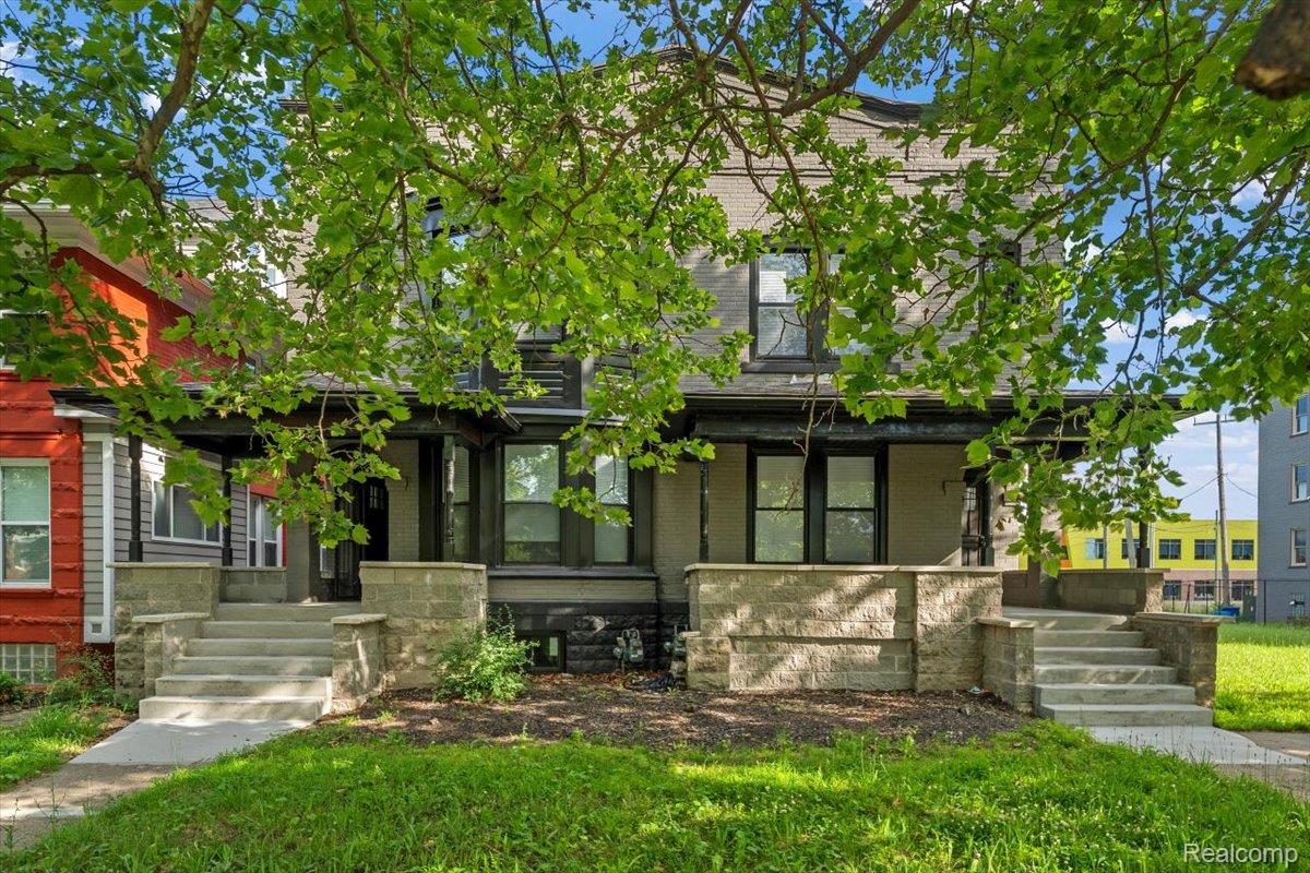 58 East Philadelphia Street Detroit, MI 48202 - Photo 2 of 24 Duplex exterior featuring two covered porches, each with concrete steps and stone block railings