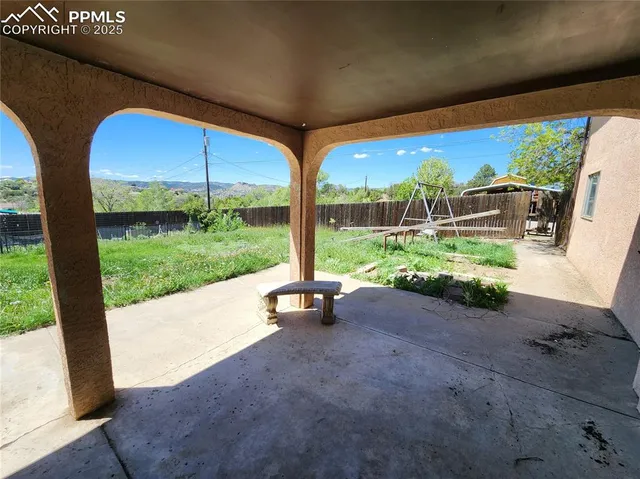 a view of a garden with an outdoor seating
