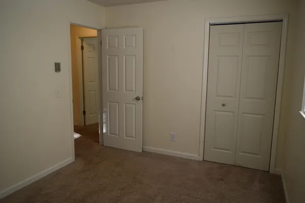 an empty room with closet area