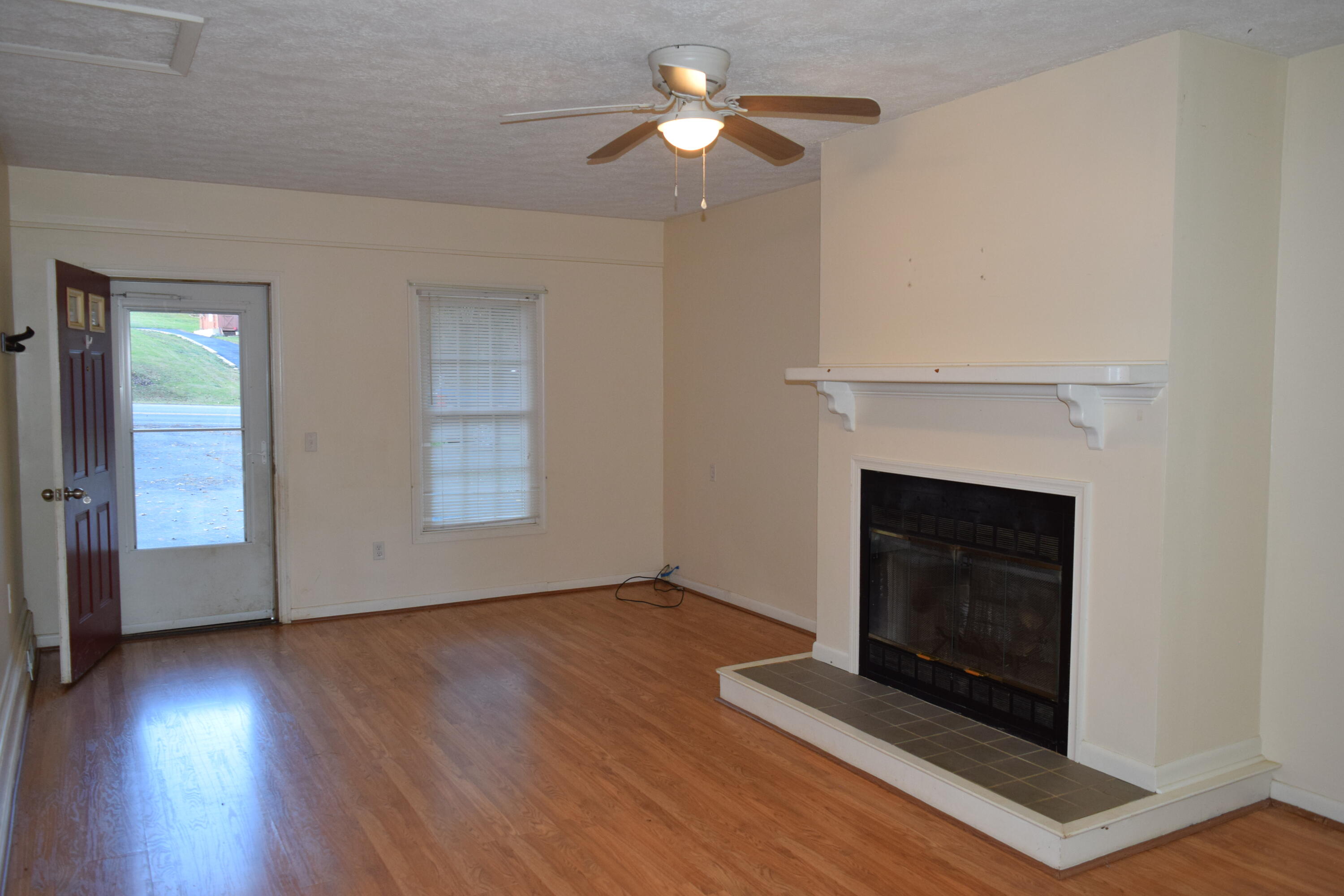 162 Ridgeview Road Northwest Floyd, VA 24091 - Photo 10 of 47 a view of an empty room with wooden floor fireplace and a window